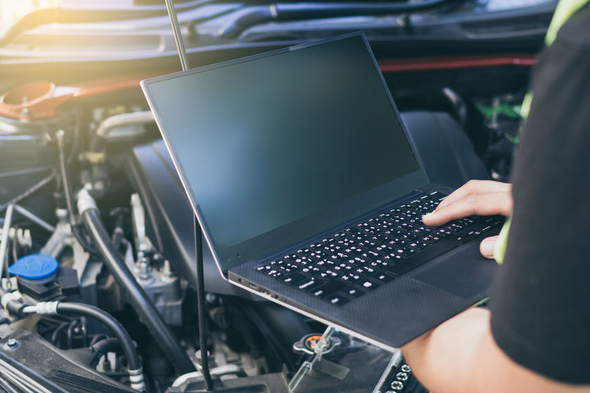 Close up engineer mechanic using electrnoic diagnostic equipmen